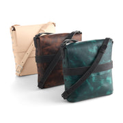 Three leather bags in beige, brown, and teal on a white background, leather kits