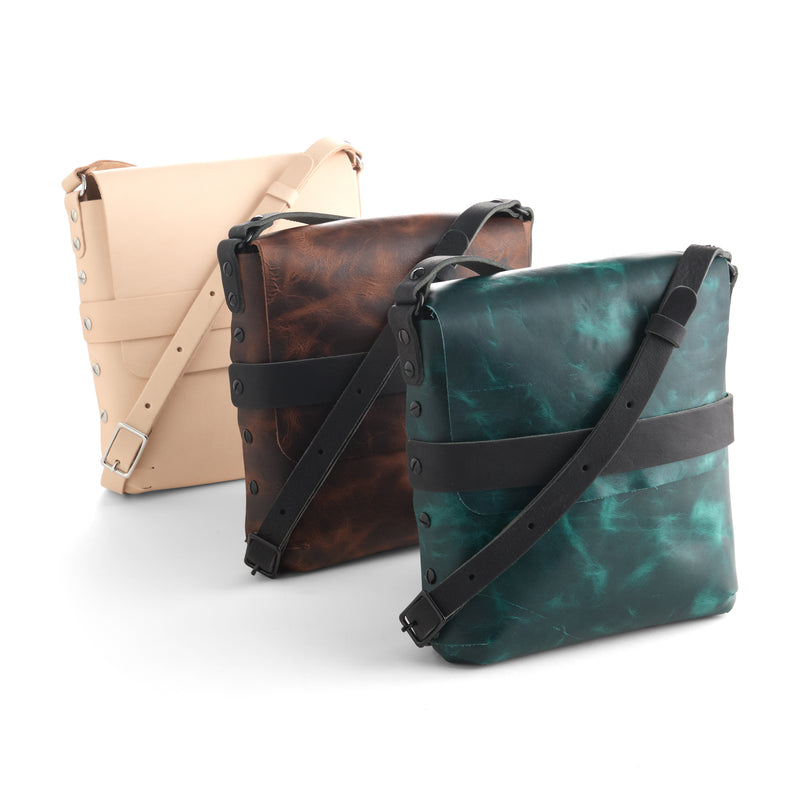 Three leather bags in beige, brown, and teal on a white background, leather kits